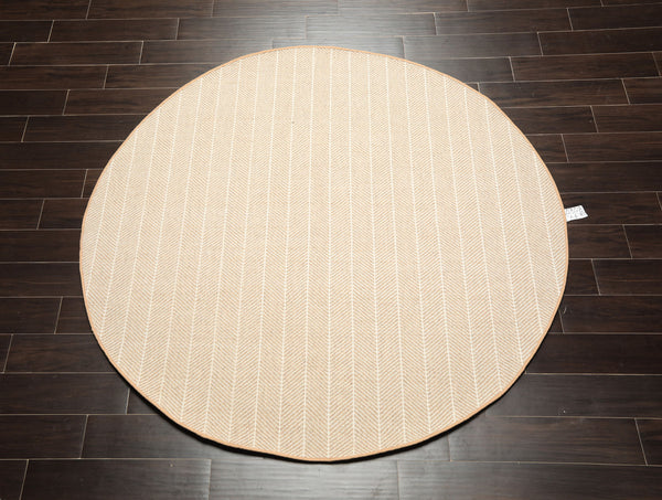 6'1'' round hand-woven wool flatweave rug in tan and ivory herringbone pattern — modern minimalist rug for living rooms and dining areas.